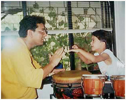Taufiq passing on finer points on percussions 
to Shikhar Naad